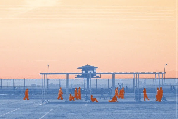 CDCr prison yard, imprisoned people in orange jumpsuits in the foreground