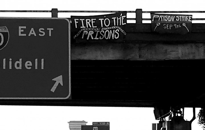 Fire to the Prisons banner drop